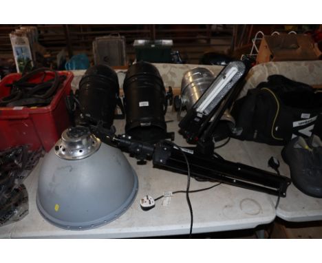 Three theatre style night units, an Angle Poise style work lamp and a light mounted a tripod base