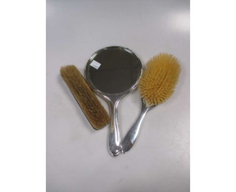 A cased set of 12 silver apostle teaspoons, a cased silver fork, knife and spoon set, a silver backed hand mirror, hair brush