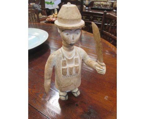 An African carved figure of a European holding a machete together with six various carved wood items