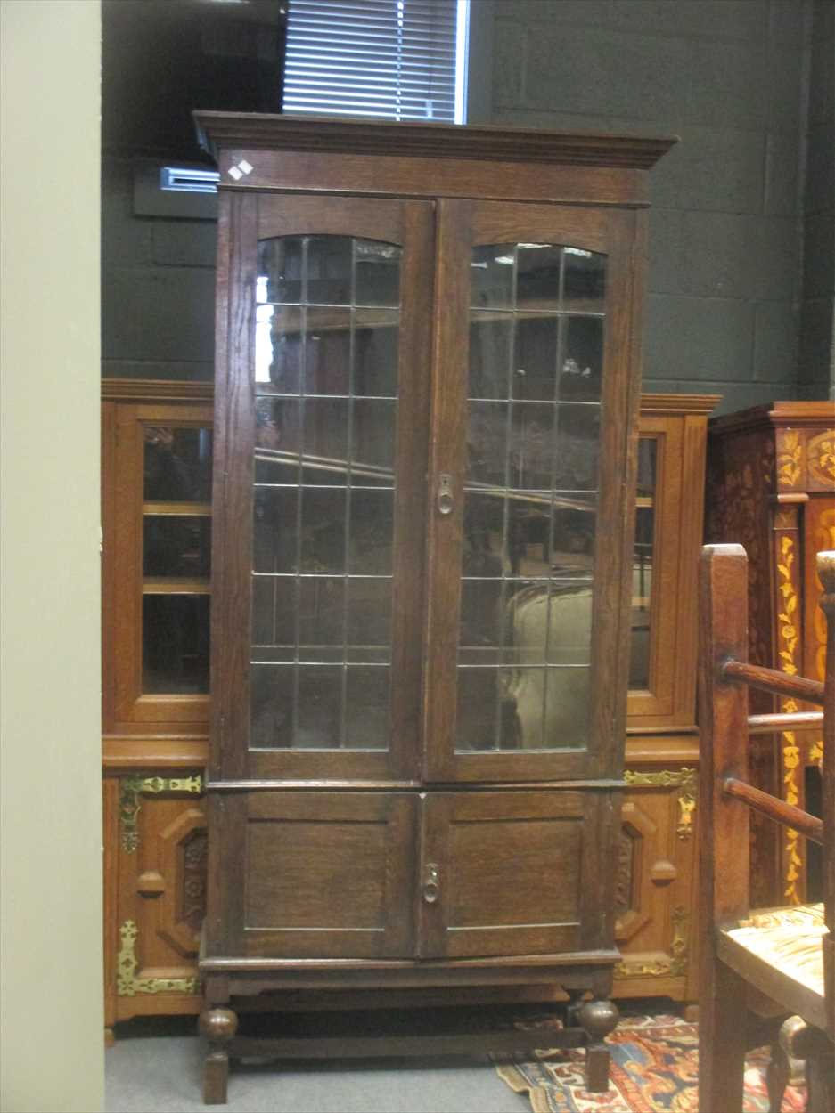 An oak bookcase with leaded glazed doors, 204 x 98 x 35cm in Cheffins