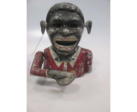 An antique automaton money box in the form of a negro with moving arm, mouth and eyes