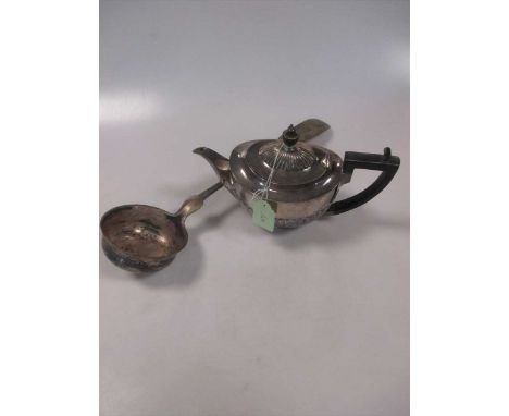 A small silver teapot, a Continental silver ladle , a small silver two handled cup, a pair of pepper casters and a small bask