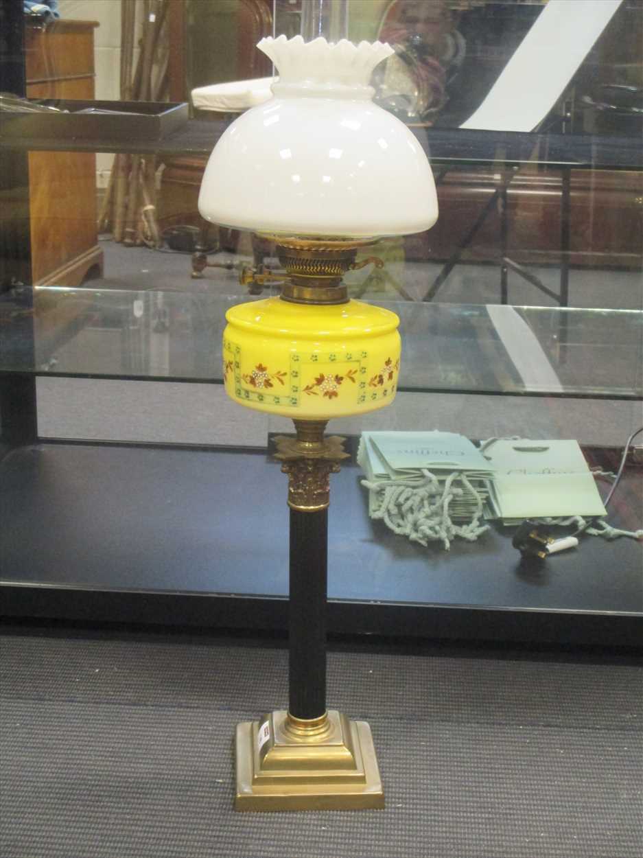 An oil lamp with yellow glass reservoir in Cheffins Fine Art