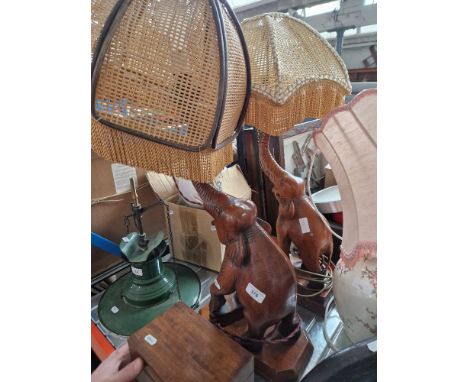 A pair of wooden carved elephants lights and a pottery table lamp. 