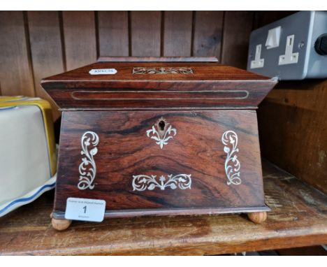 A 19th century rosewood and mother of pearl tea caddy. 