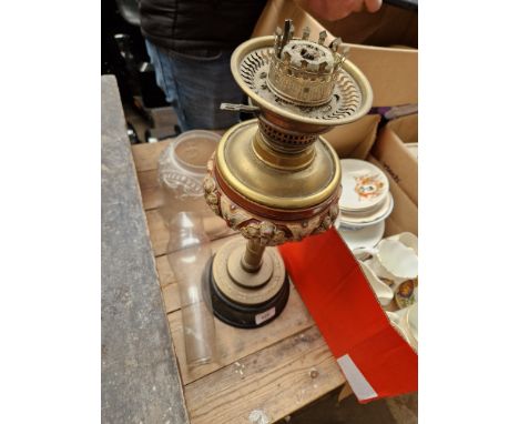 An antique paraffin lamp with shade and funnel. 