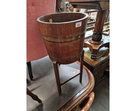 A brass bound oak planter on stand by R. Alister &amp; Co Ltd, Dursley, England. 