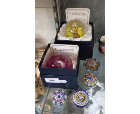 Two boxed Caithness glass paperweights together with four others. 