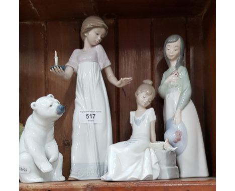 Three Nao figurines and Lladro polar bear figurine. 