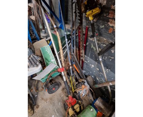 A quantity of garden tools including two petrol strimmer/brush cutters, electric chainsaw, lawn feeders and liquid feed, hedg