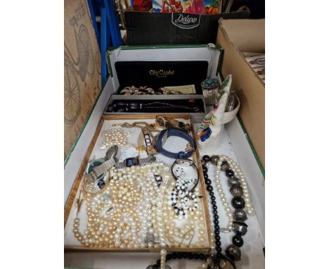 A box containing costume jewellery, vintage watches and a Staffordshire pottery pocketwatch holder. 