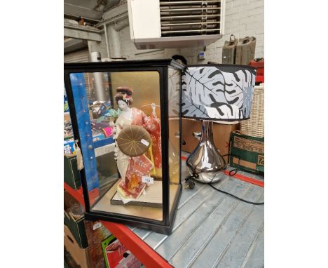 A cased Geisha, an earthenware bread crock and a table lamp. 