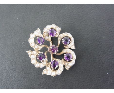 An amethyst and seed pearl flower brooch - Stamped 14K - Length 2.8cms - clean condition - approx weight 5.2 grams