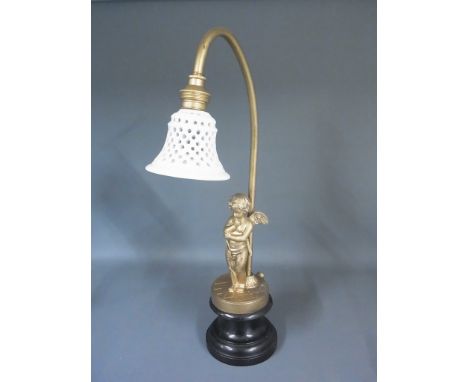 A gilt figural table lamp with Cupid resting on his bow and a ceramic lamp shade - Height 37cm - overall good condition, has 