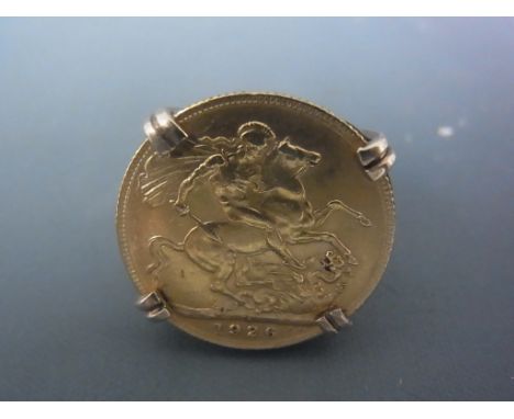 A full Sovereign dated 1926, George V set in a 9ct yellow gold ring mount size R - approx weight 13 grams - good clean condit