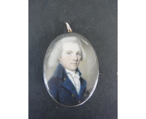 A 19th century gilt metal mourning brooch with a miniature portrait of a gentleman and lock of hair verso - 4cm x 3cm