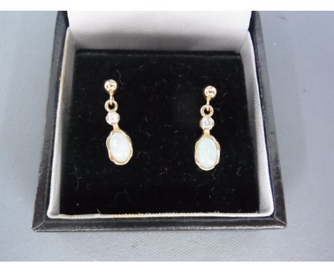 A pair of 9ct opal and diamond earrings - 1.6cm - weight approx 1.4 grams