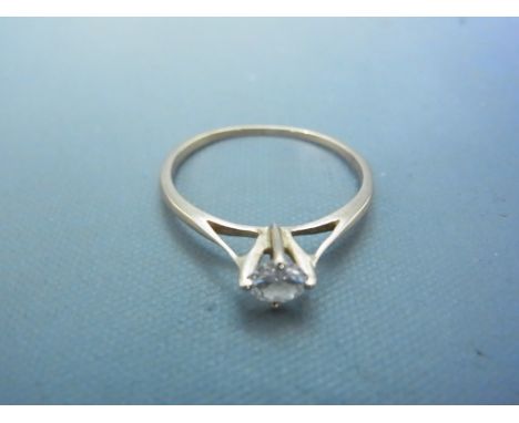 An unmarked yellow gold ring with approx 0.25ct diamond to shoulder - ring size K - approx weight 1 gram - clean and bright