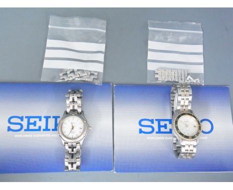 Two Seiko ladies watches, one titanium and one SQ50 both with extra links and booklets - both in good condition