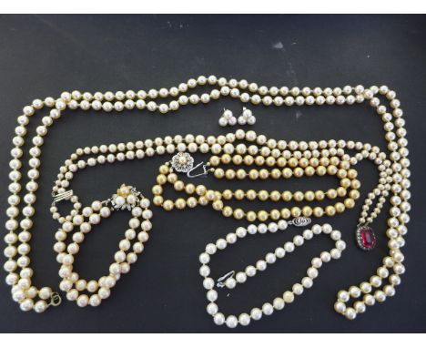 Four pearl necklaces, three with clasps marked as silver, a pair of triangular form pearl earrings and a pearl bracelet 