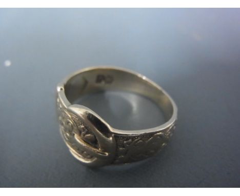 A 9ct yellow gold ring in the form, of a belt - ring size R - approx weight 5 grams - good clean and bright condition