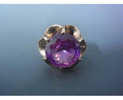 A 9ct yellow gold dress ring with central large amethyst coloured stone - approx weight 5.1 grams - ring size K/L