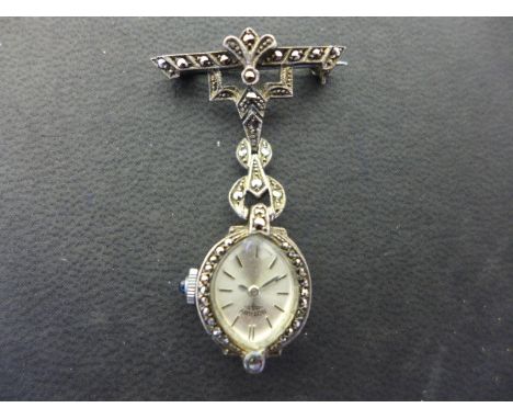 A Rotary Nurses watch set in silver and marcasite case on brooch Condition report: Good condition 