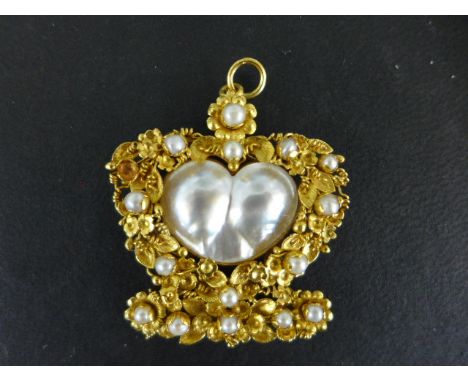 A late 19th/early 20th century gold seed pearl and cultured pearl pendant - The heart-shape blister pearl (23x15mm) within a 