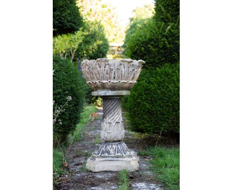 A Victorian buff terracotta planter on a writhen support, the leaf moulded bowl broken and with repair beneath the meeting be