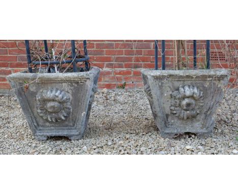 A pair of cast reconstituted stone planters of square tapering form with flower head ornament to each panelled side, 53cm wid