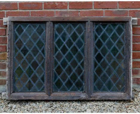 An antique oak framed leaded light window in three sections with moulded mullions, the window 107cm wide x 72cm highIn very w