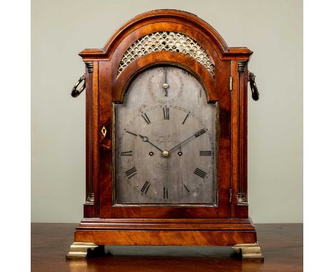 A George III mahogany bracket or table clock, the break arch silvered Roman dial with strike silent ring to the arch, signed 