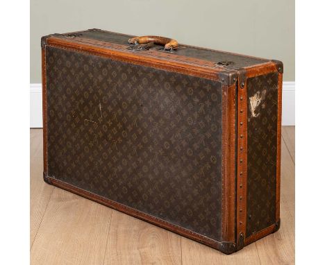 A vintage Louis Vuitton suitcase, early 20th century, with leather carrying handle, the lock numbered 075814 and numbered 787