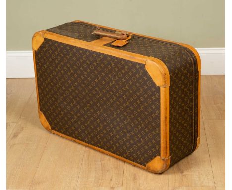 A Vintage Louis Vuitton suitcase with brass clasp and combination lock, 85cm wide x 27cm deep x 54cm highPurchased from Louis