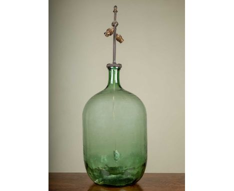 A decorative table lamp with carboy bottle base, 82cm highIn need of rewiring otherwise in good condition.