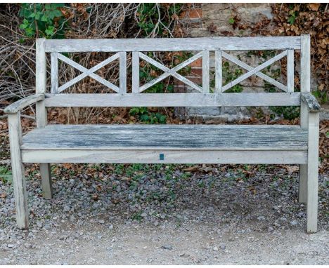 A teak garden bench with X shaped splats to the back, 150cm wide x 92cm highWeathered with some signs of rot to the joints. S