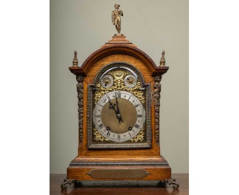 A late 19th century Winterhalder &amp; Hofmeier oak bracket or table clock, the break arch brass dial with silvered Roman cha