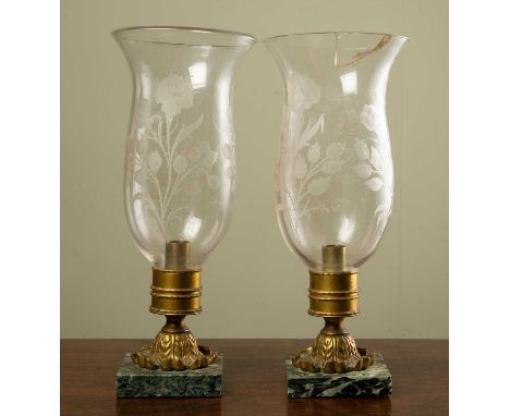 A pair of storm lamps with cut glass shades, gilt metal mounts and marble plinths, the shades decorated with roses, each 14.5