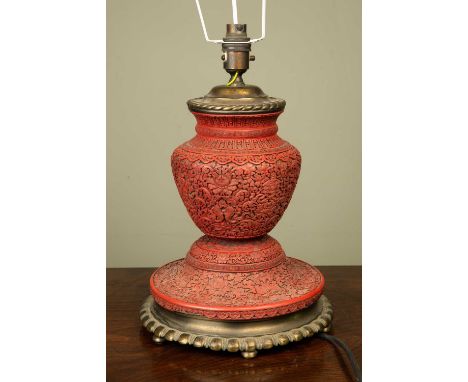 A decorative table lamp with Chinese cinnabar lacquer body and gilt metal mounts, 25cm diameter x 38cm high to the light fitt