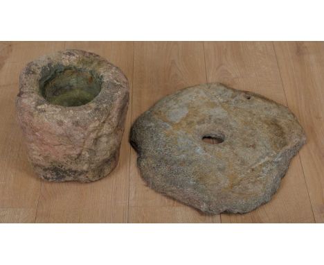 A Scottish pink sandstone stone 'Knocker' mortar, 23cm diameter x 22.5cm high; together with a pre-medieval stone quern top, 