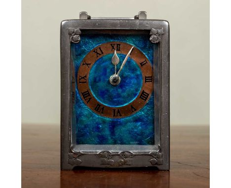 Attributed to Archibald Knox (1864-1933) a pewter carriage timepiece, a bluey-green mottled enamel dial with copper Roman cha