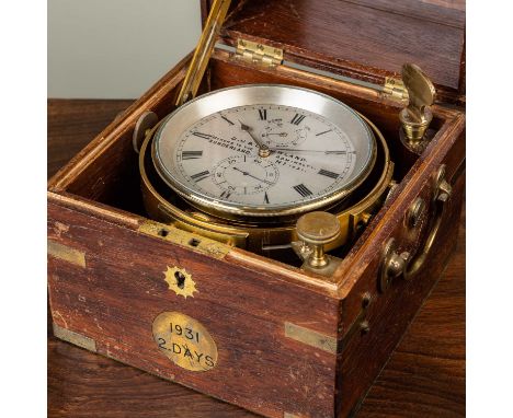 A two-day marine chronometer by Gowland in a brass-bound mahogany case, the chronometer mounted on a gimbal, the silvered dia