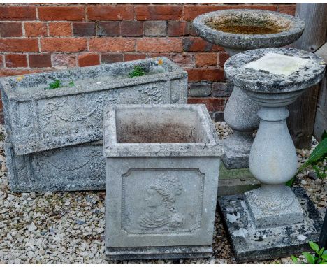 A cast reconstituted stone bird bath on a baluster stand, 44cm diameter, together with a matching bird table; two rectangular