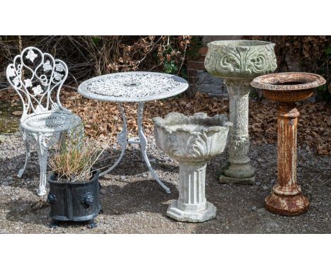 A collection of garden ornaments and furniture to include a white wrought iron bistro or garden table, white painted with scr