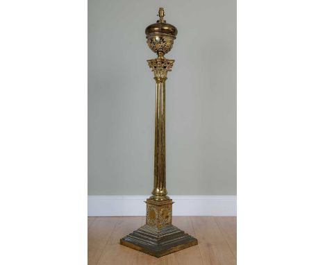A Victorian heavy and substantial gilt brass lamp standard of Corinthian column form on a stepped base decorated with female 
