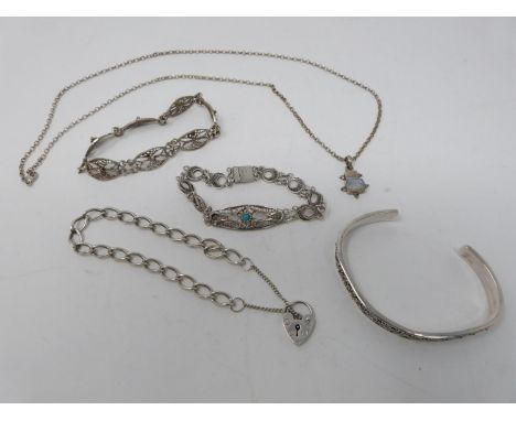 A collection of silver jewellery. Including a silver charm bracelet with heart padlock, a rainbow moonstone set pendant on si