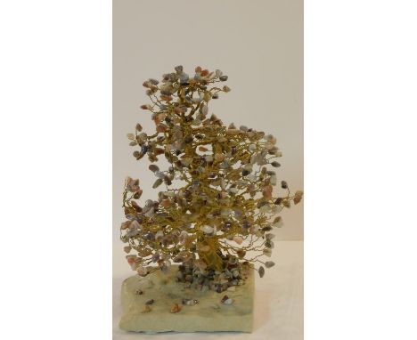 A vintage brass and agate tree on a stone slab base. The leaves are each chips of various coloured agates and the trunk is ma