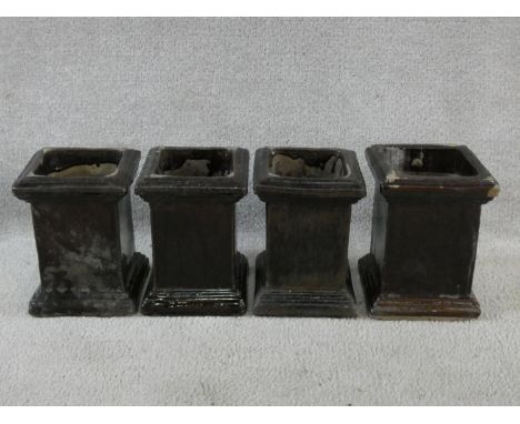 A set of four ceramic planters in grey glaze on stepped bases. H.23cm 