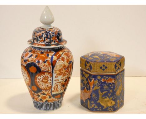 A Chinese lidded temple jar with all over Imari style decoration and a lidded hexagonal caddy with swimming goldfish decorati