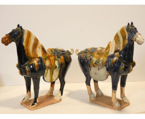 Two Tang style ceramic horse figures in blue and ochre glaze. H.37 W.40 D.14cm 